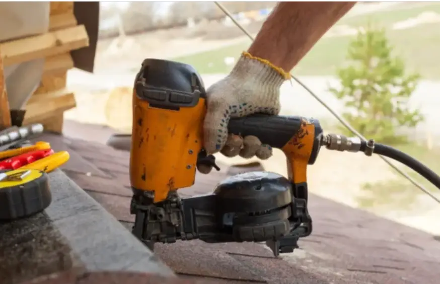 Construction worker holding a nail gun