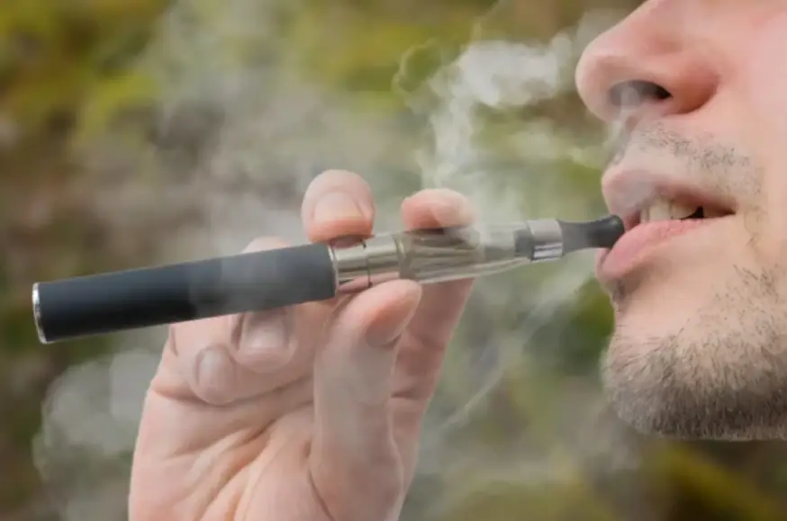 A man smoking an e-cigarette