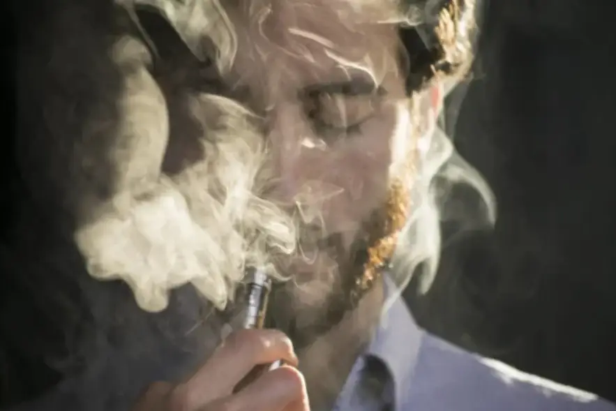 a man smoking a vape