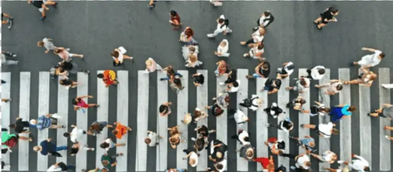 a crowded crosswalk filled with pedestrians