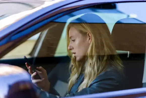 a woman texting while driving