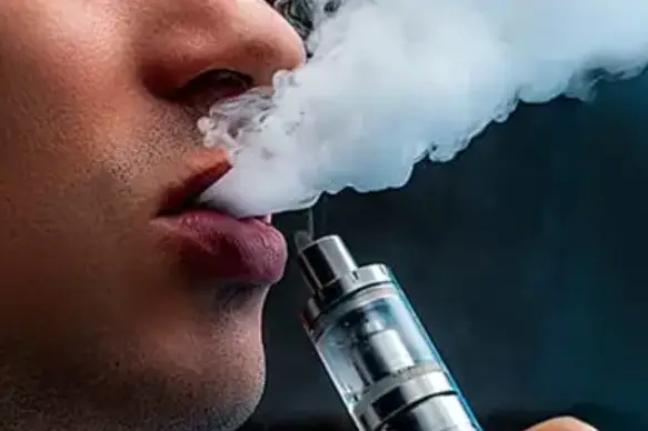 a man smoking an e-cigarette