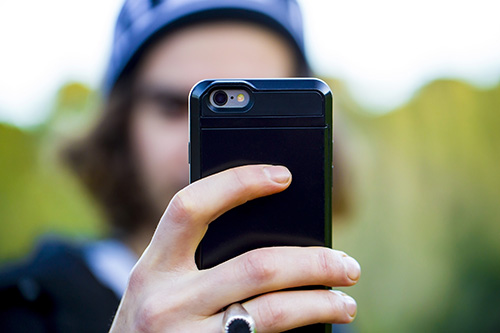 man taking photo with a smart phone
