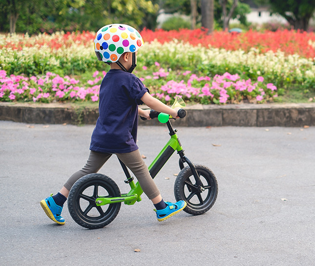 Little boy on bike in the street