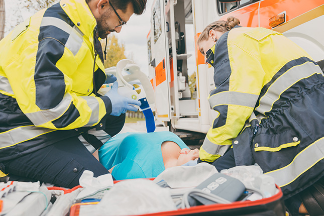 ambulance tending to hurt woman on the ground