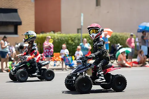 child in atv on street
