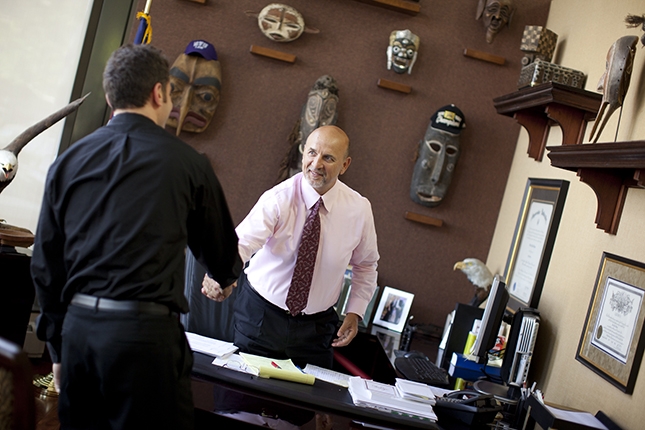 Skilled Anaheim truck accident attorney John Bisnar shaking the hand of a client