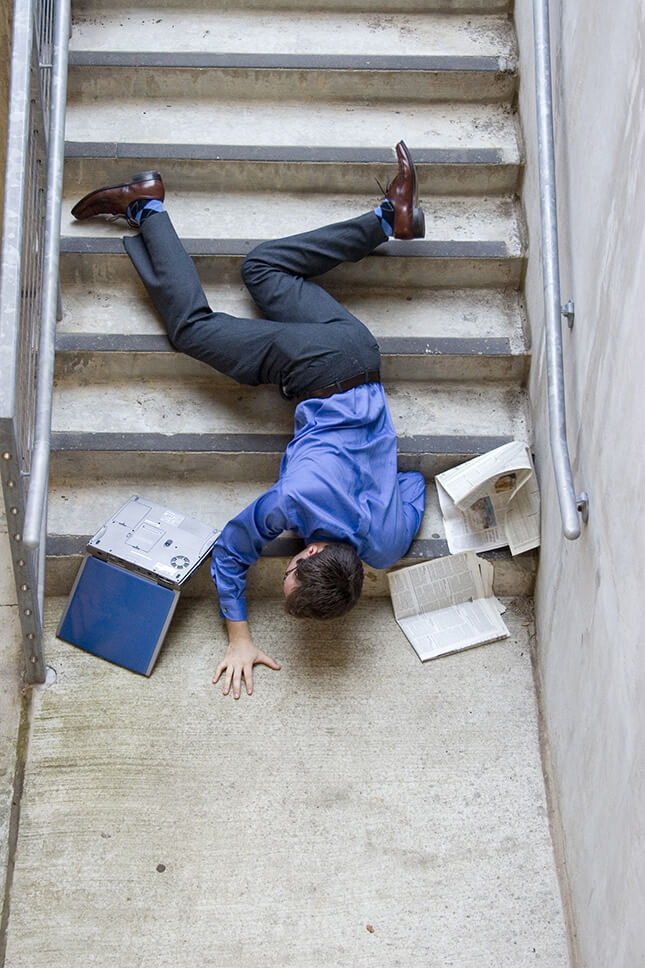 person on floor after falling off a staircase