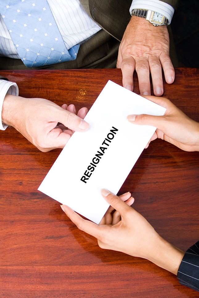 Person handing over resignation sign.