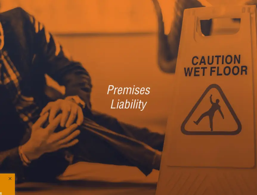 a wet floor sign and an injured man