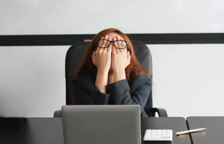 A worker suffering office burnout sitting at her desk