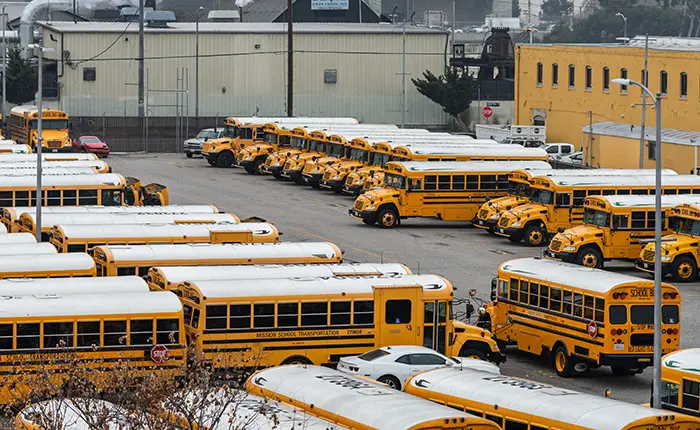 A parking lot filled with school buses in California