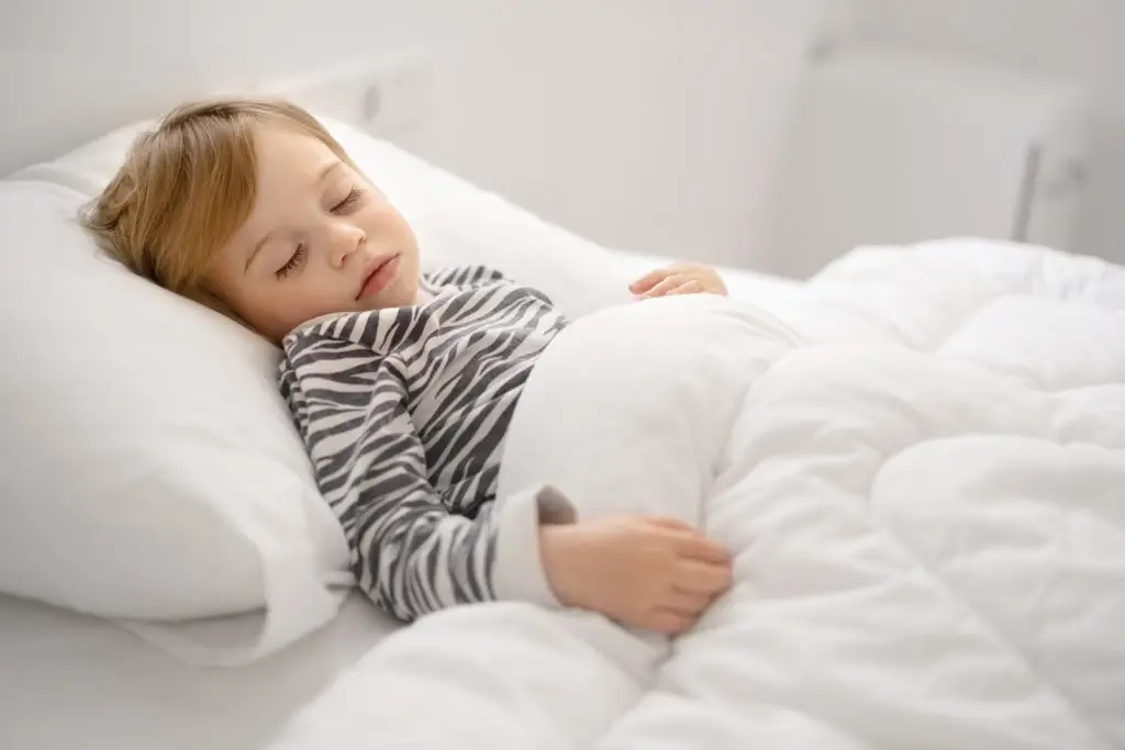 A child sleeping under a weighted blanket