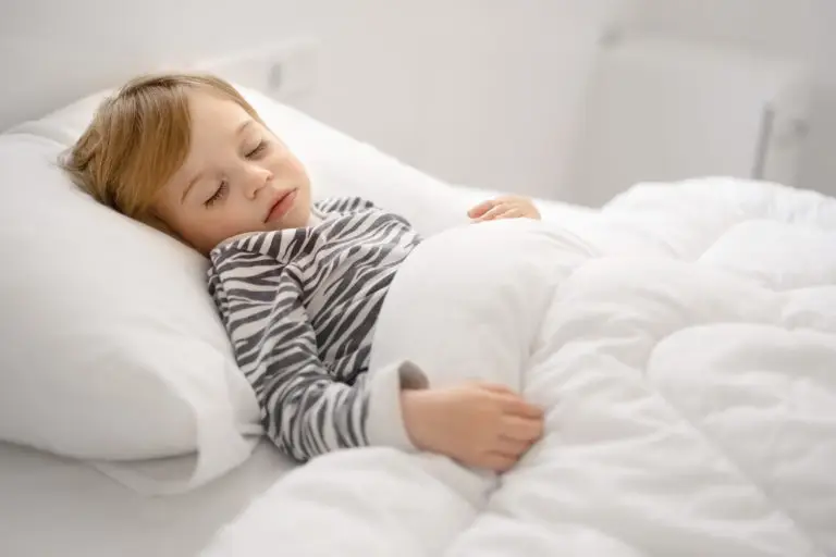 A child sleeping under a weighted blanket