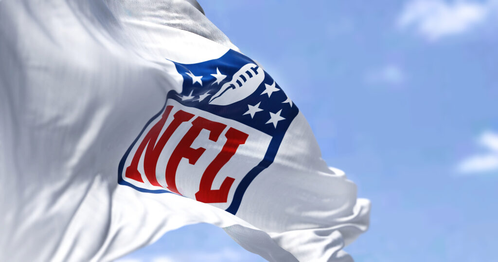 A flag flying with the NFL logo on it.