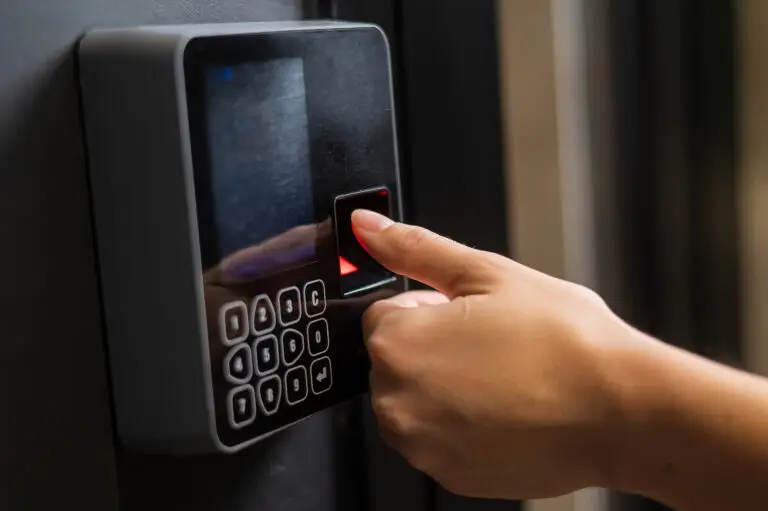 A person using the fingerprint feature on a safe