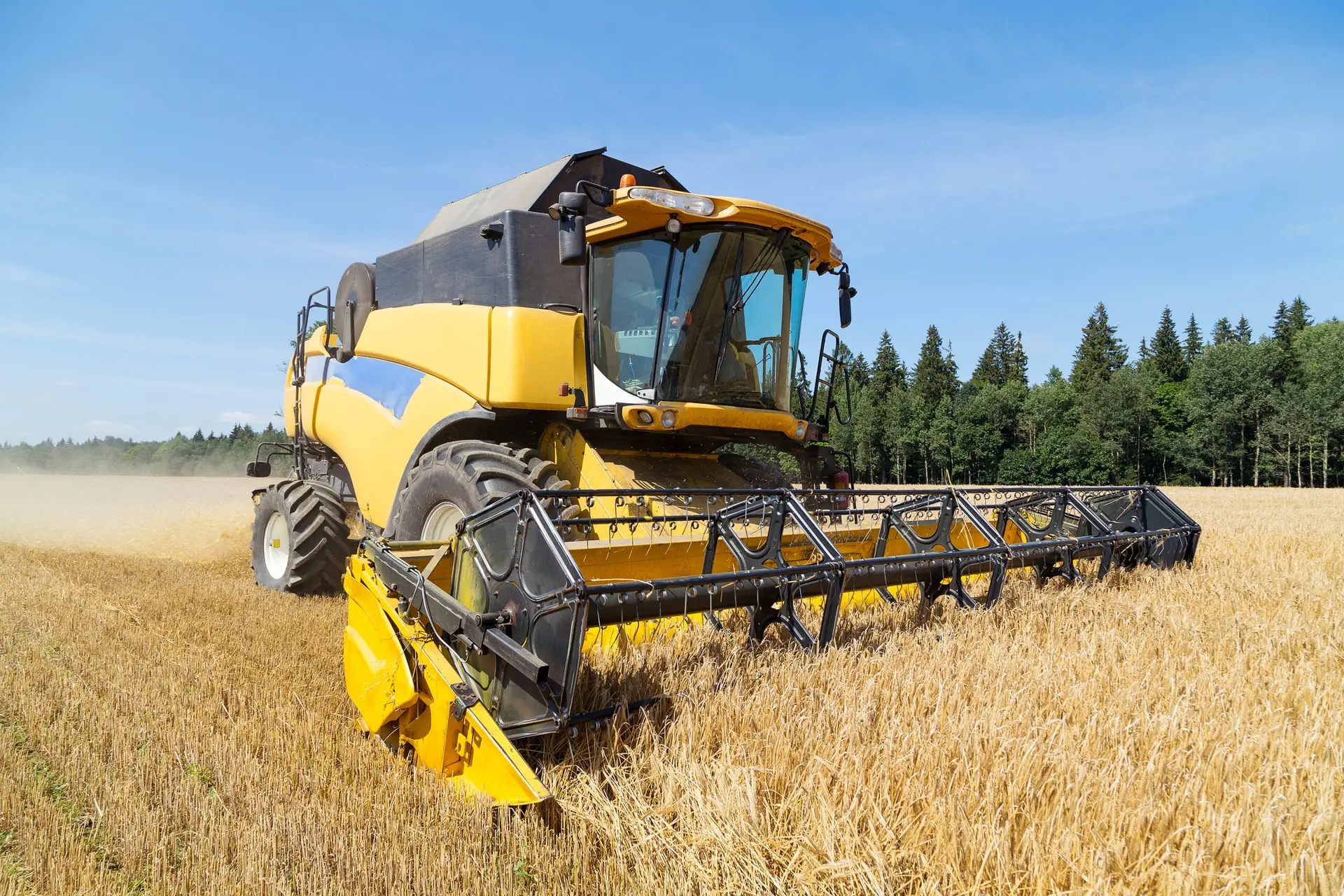 A combine harvester working on a farm